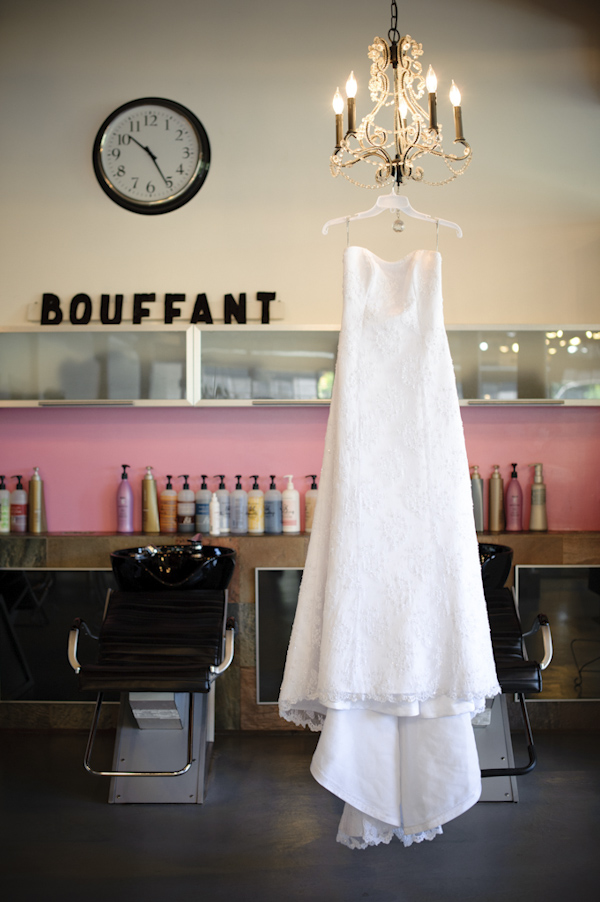 bride's A line dress hanging from chandelier - wedding photo by top Portland, Oregon wedding photographer Aaron Courter